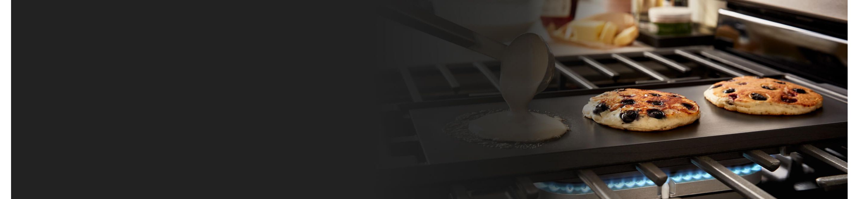 Pancakes cooking on a stovetop griddle