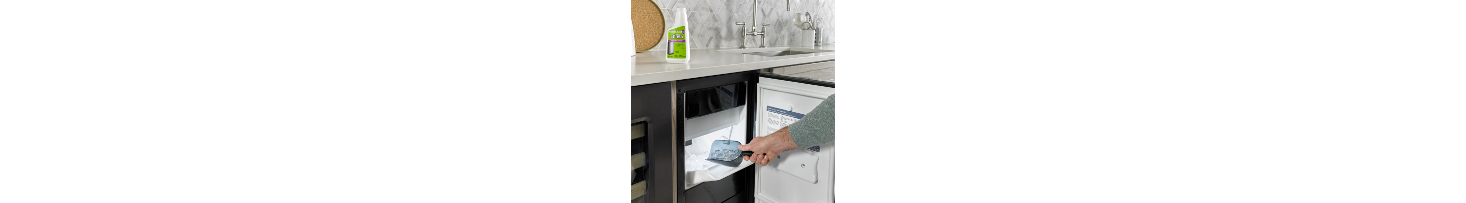 Person scooping ice out of an icemaker