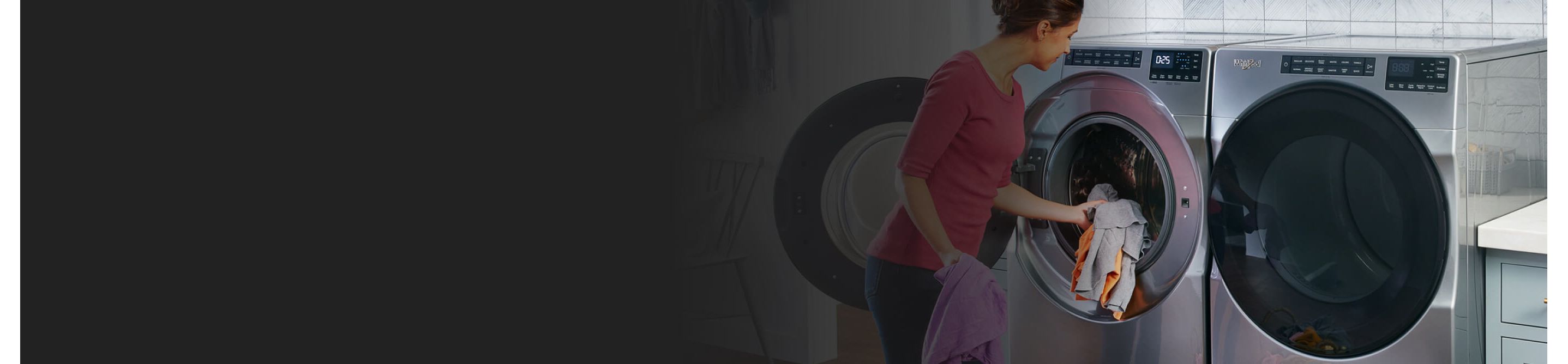 Person loading clothes into a front load Whirlpool brand washer