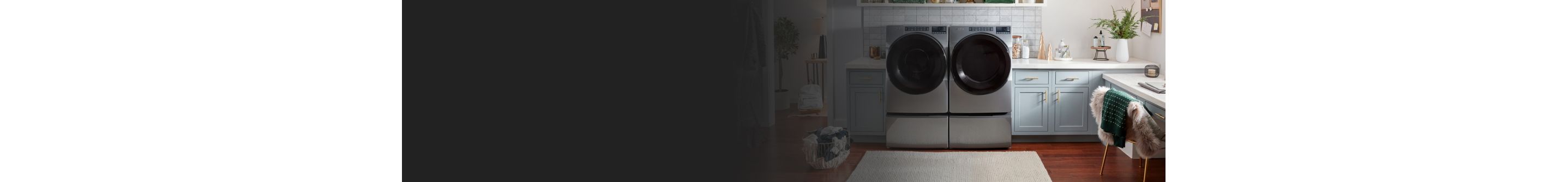 Whirlpool® Front Load Washer and Dryer pair on pedestals in a laundry room 