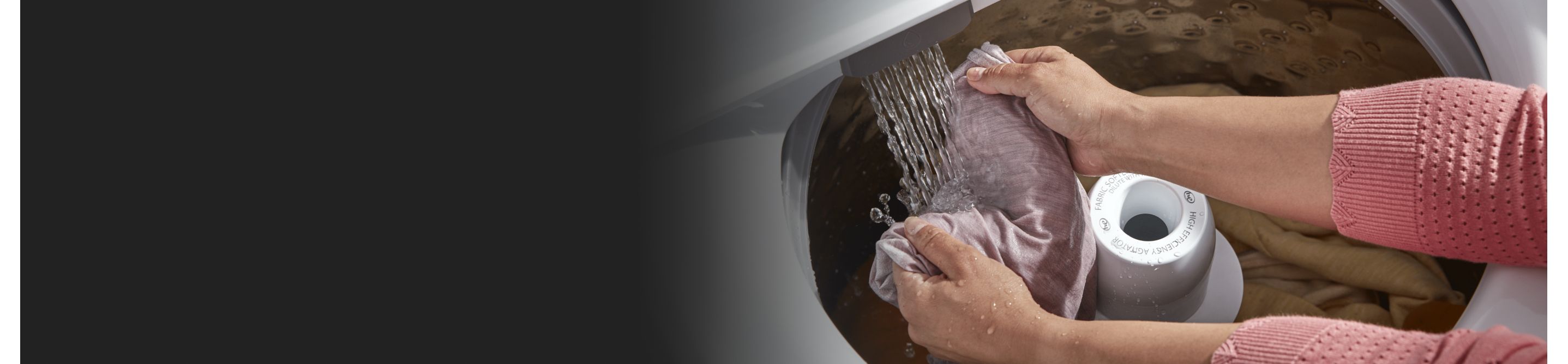 Person hand-rinsing laundry in a Whirlpool® Top-Load Washer
