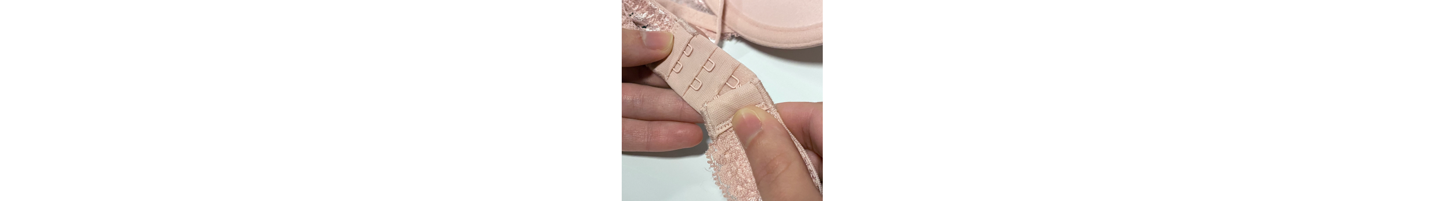 Person closing the hooks of a bra