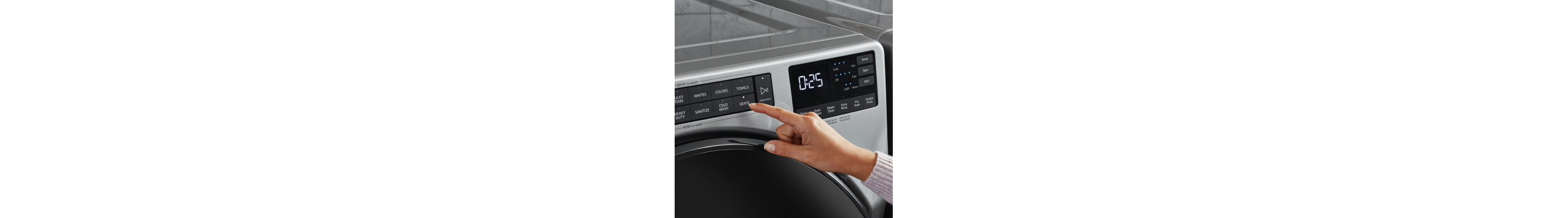 A finger pressing a laundry wash cycle