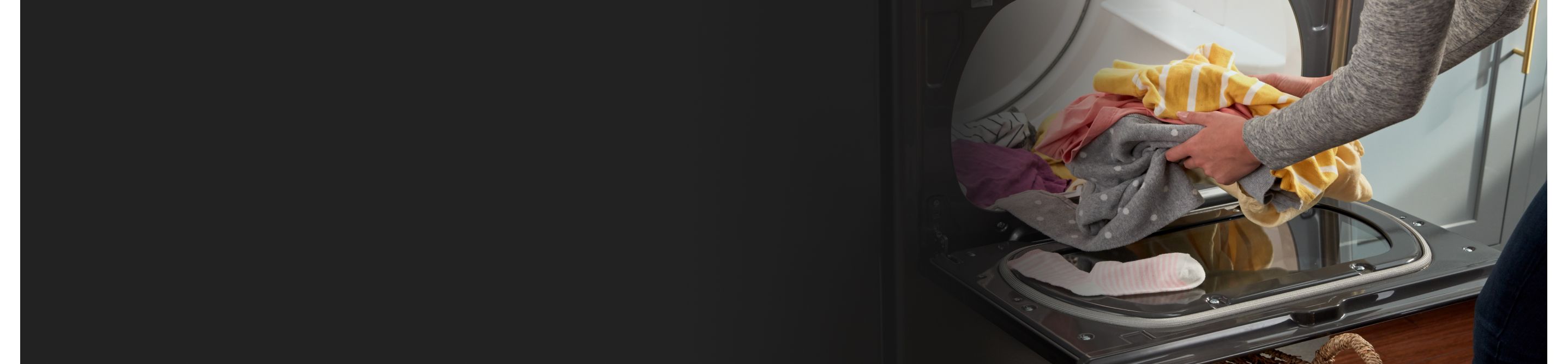 Person unloading a Whirlpool® dryer