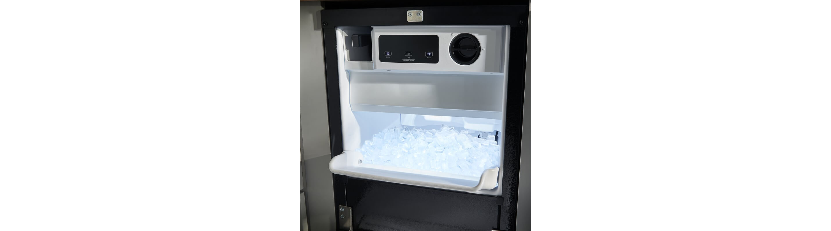 Open black icemaker full of ice cubes
