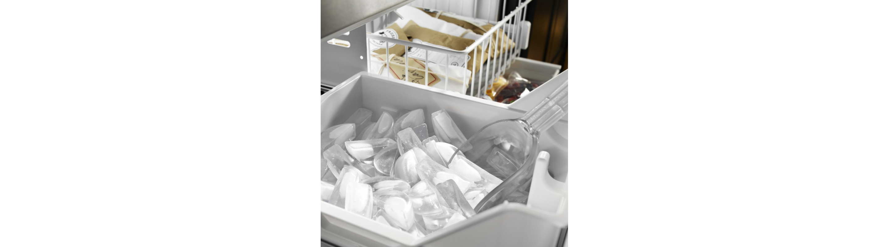 Scoop inside an ice bin located in a pull-out freezer drawer