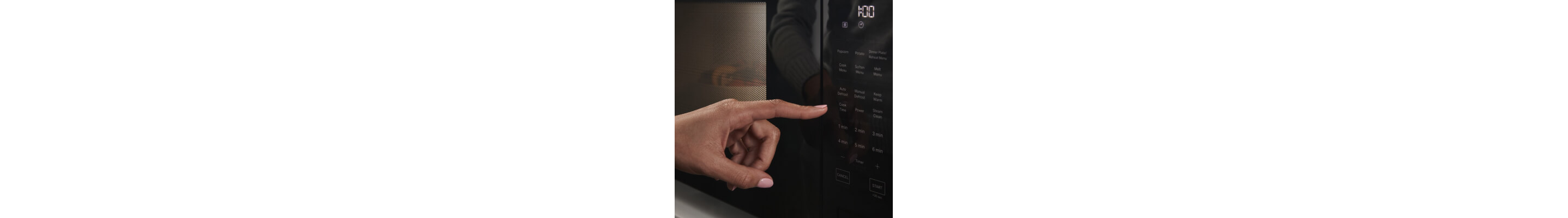 Person selecting settings on a microwave touchpad