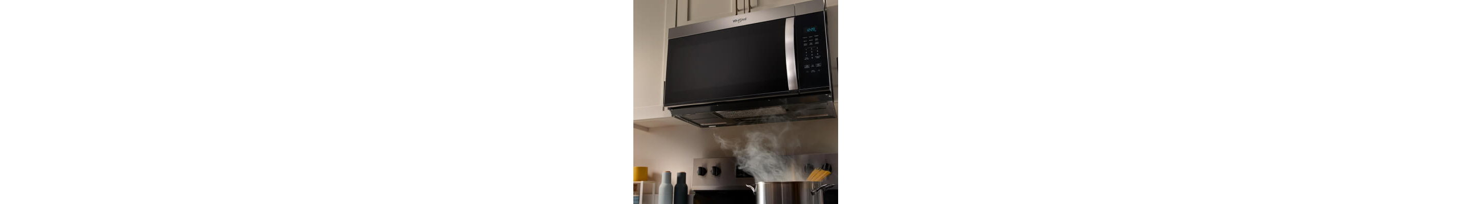 Stockpot of spaghetti cooking below a Whirlpool® Over-the-Range Microwave