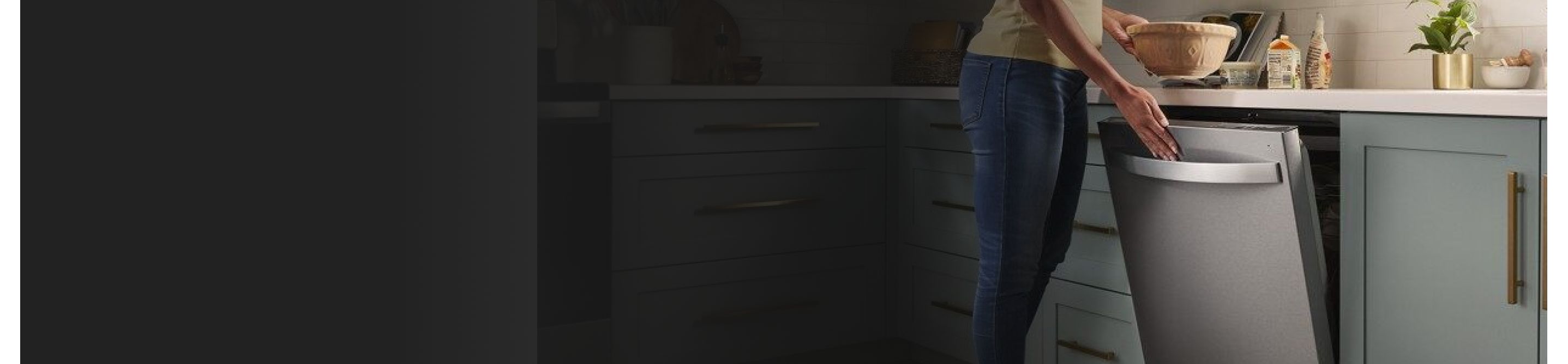 A closeup of a person opening a Whirlpool® dishwasher.
