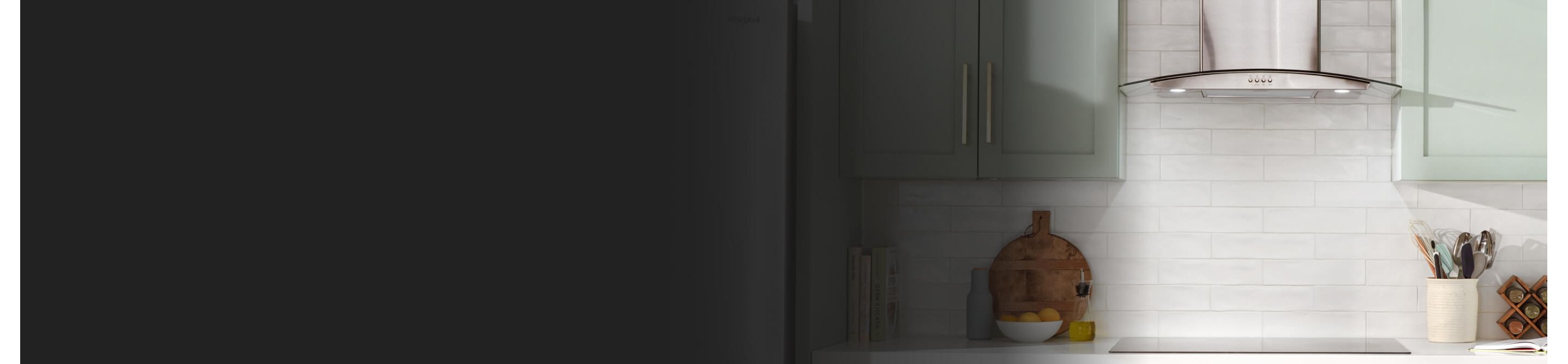 A range hood between teal cabinets