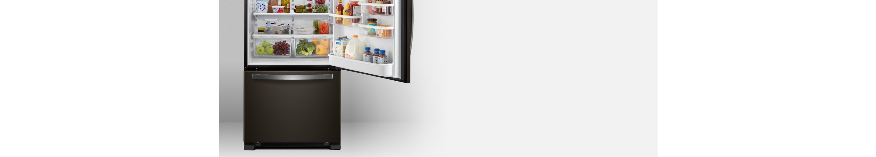 An open Whirlpool® bottom freezer refrigerator