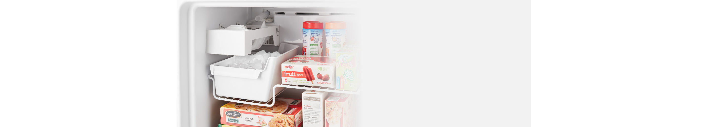 A closeup of an open Whirlpool® top freezer refrigerator