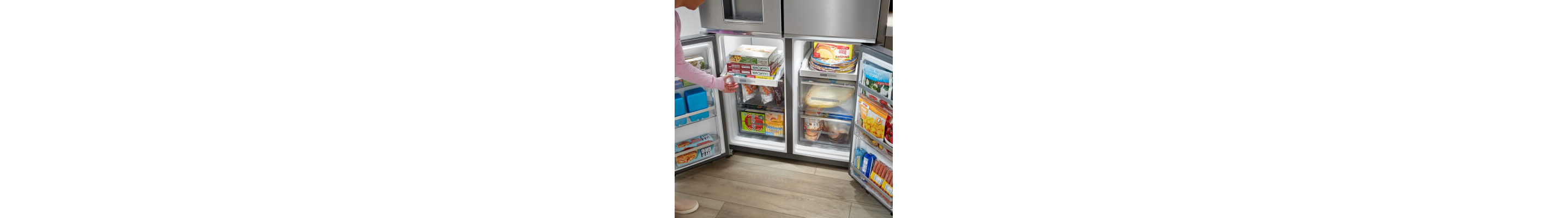 A four door refrigerator with opened bottom compartments