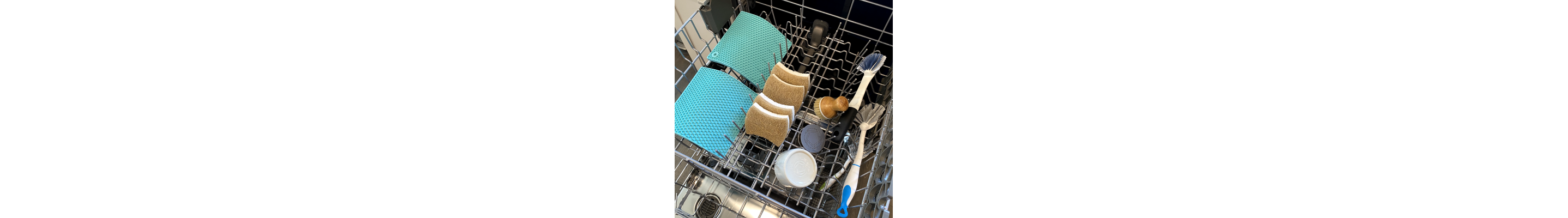 A variety of items being washed on the top shelf of a dishwasher