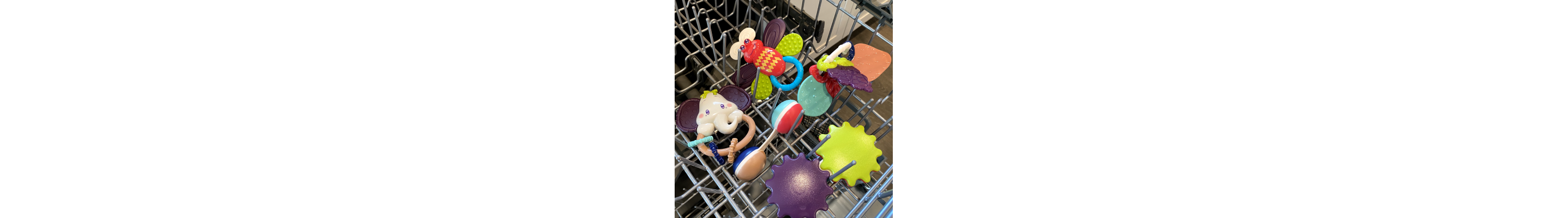 Kids toys and accessories on the top rack of a dishwasher