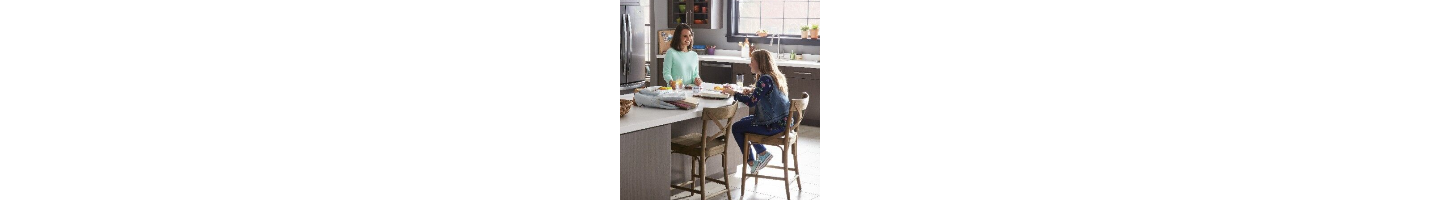 Two people talking at a kitchen island