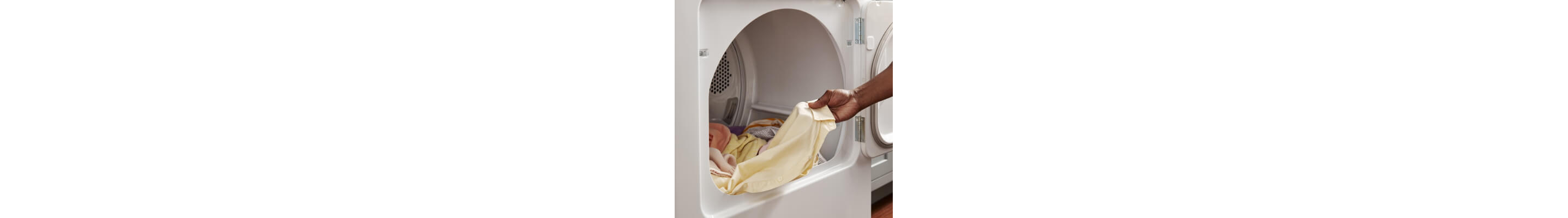 Close up of a person unloading a Whirlpool® Dryer