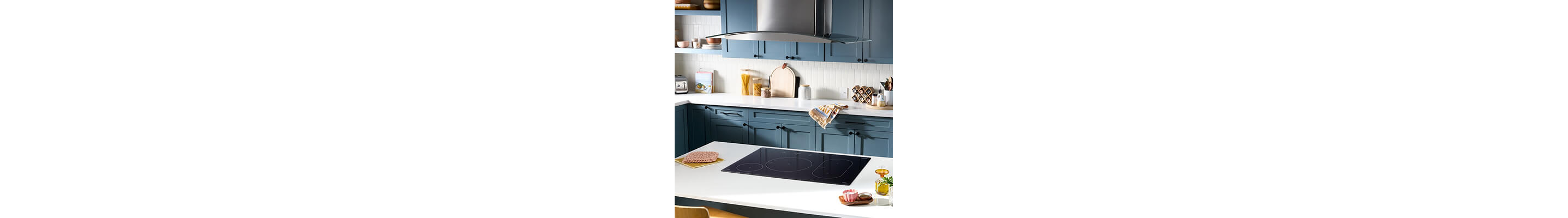 Electric cooktop built into white kitchen island countertop
