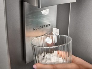 Someone getting nugget ice at a fridge dispenser