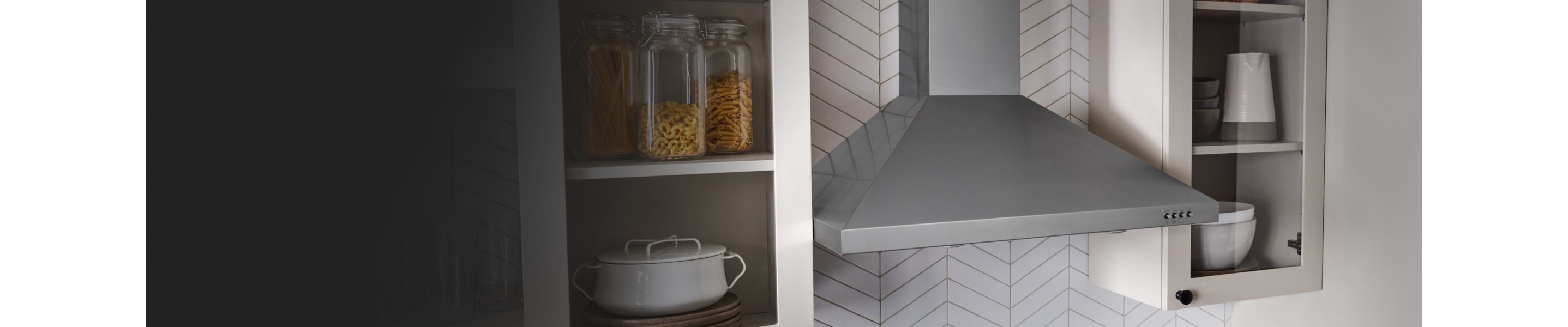 A canopy hood installed between cabinets.