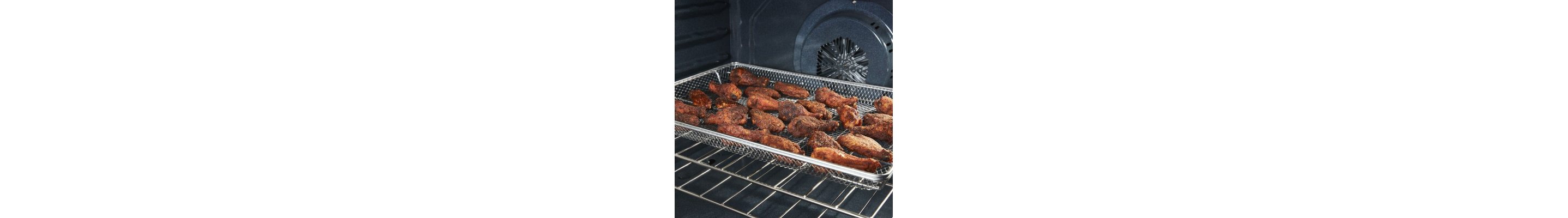 Chicken wings cooking in an air fry oven