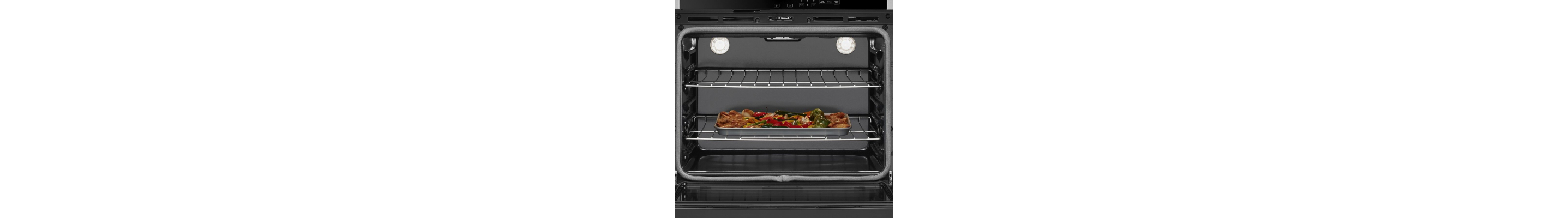 Chicken and vegetables roasting in a conventional oven
