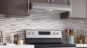 A Whirlpool® Under Cabinet Range Hood and Range in a kitchen