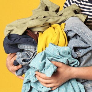 Someone holding a stack of mixed laundry