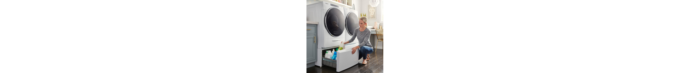 Person opening the drawer of a laundry pedestal