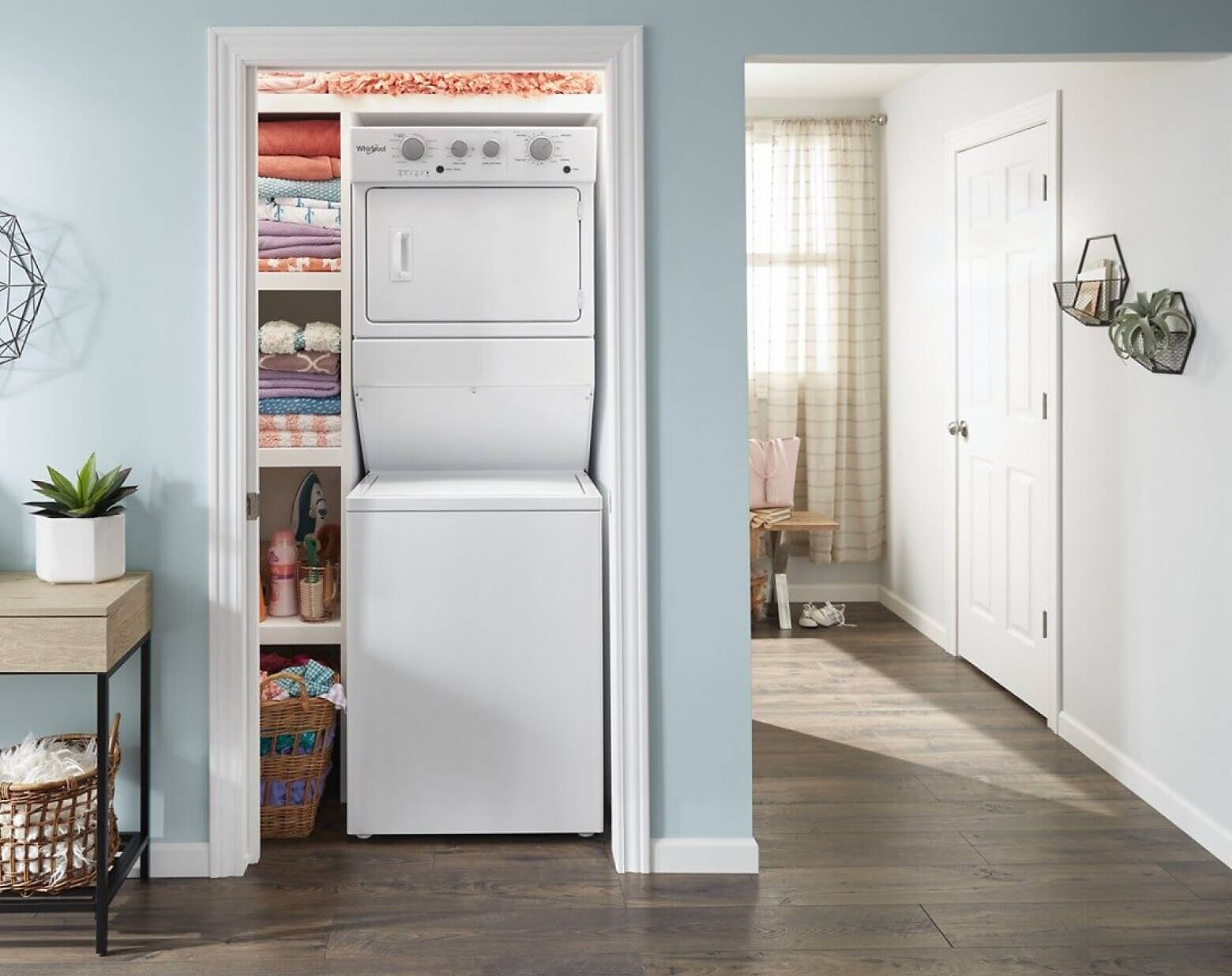 A Whirlpool® Stacked Laundry Center tucked into a closet of a modern home