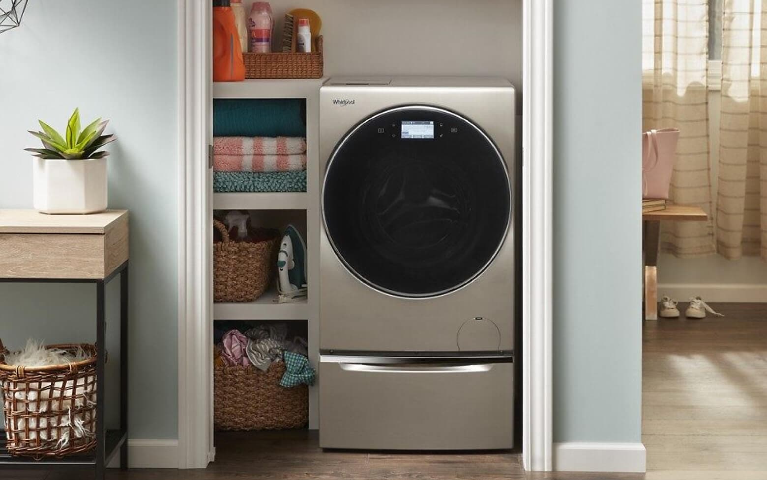 A Whirlpool® Smart All-In-One Washer & Dryer tucked into a closet of a modern home