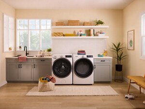 A laundry area with a white Whirlpool® Front Load Washer and Dryer