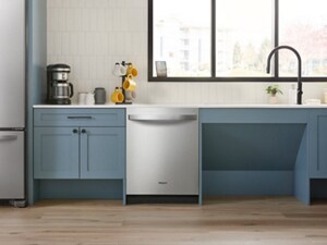 The inside of a kitchen with blue cabinetry and a stainless steel dishwasher