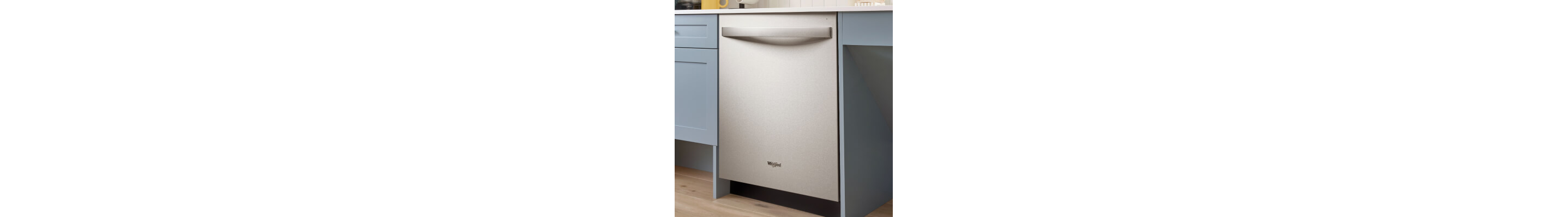 A Whirlpool® Built-In Dishwasher with Top Control and a towel handle between powder blue cabinets