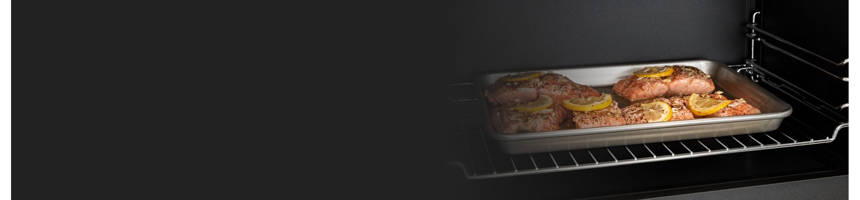 Salmon filets on a sheet pan inside a microwave
