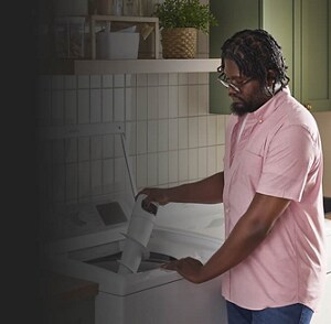 A person putting a removable agitator in their washer