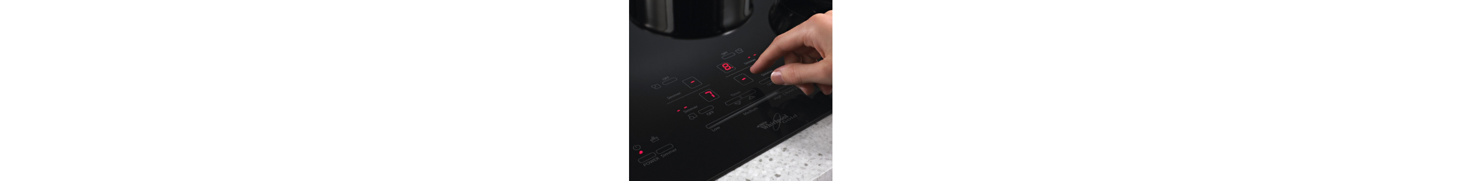 A hand choosing settings on a Whirlpool® Induction Cooktop
