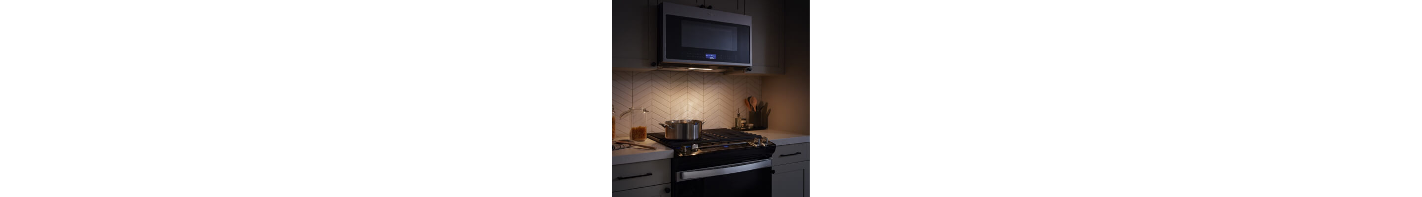 A microwave light illuminating the top of a stove