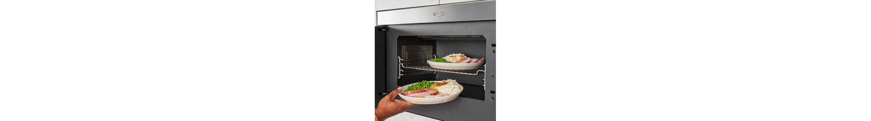 A person adjusting food in a microwave