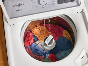 White open washing machine including colored clothes