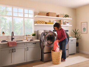 A woman sorting clothes in the midst of doing laundry in a laundry room