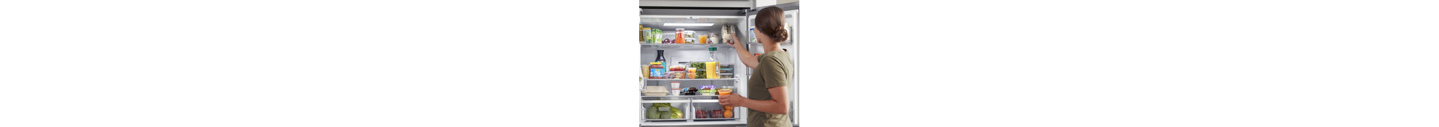 Person loading food into a refrigerator