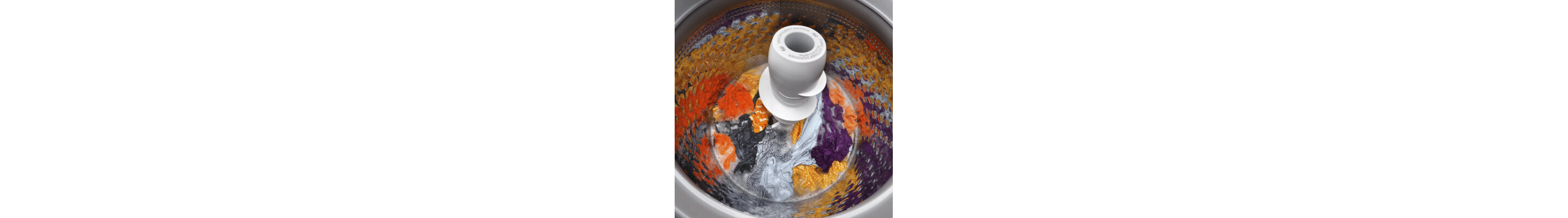 Bright load of clothing soaking inside a top load washer