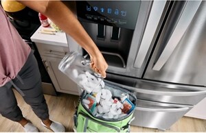 A person filling a cooler with ice cubes from their Whirlpool® Refrigerator's ice dispenser