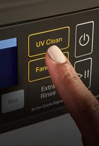 A person pressing the UV Clean button on a washer