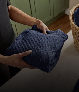 A person folding laundry