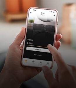 A stacked laundry set with an open Whirlpool® app in front