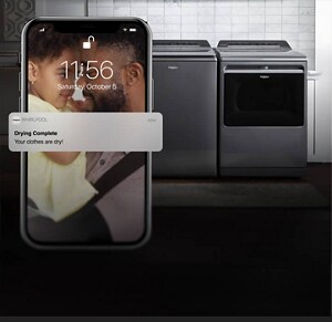 Whirlpool® appliances with a phone in front of it