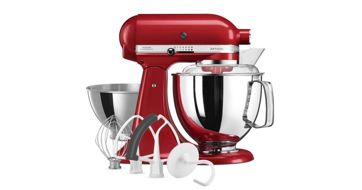 A red tilt-head stand mixer with a stainless steel bowl and a pouring shield fitted.